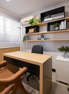 an office with a desk, chair and shelves filled with plants on the top shelf