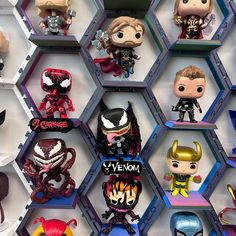 many pop - up action figures are displayed on hexagonal shelves in this photo