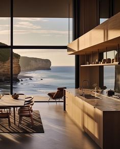 a dining room table and chairs near the ocean