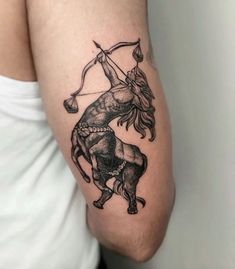 a man with a tattoo on his arm holding an arrow and aiming the bulls into the sky