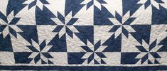 a blue and white quilt with arrows on it