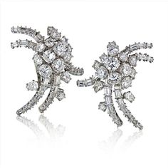 These exquisite French Circa 1960's Platinum 12 Carat Diamond Estate Earrings are a testament to timeless elegance and sophistication. Handcrafted in France, these earrings exude a sense of old-world charm and impeccable craftsmanship.The centerpiece of these earrings is a dazzling 12-carat diamond, radiating brilliance and capturing the light with every movement. The platinum setting adds a touch of luxury and durability, ensuring that these earrings will be cherished for generations to come.Wi Classic Clip-on Diamond Earrings, Formal Bridal Diamond Clip-on Earrings, Formal Platinum Cluster Earrings, Luxury Cluster Earrings For Formal Occasions, Timeless Evening Earrings With 17 Jewels, Formal White Gold Clip-on Diamond Earrings, Classic Bridal Earrings With 17 Jewels For Anniversary, White Gold Clip-on Diamond Earrings For Formal Events, Diamond White Earrings With 17 Jewels For Evening