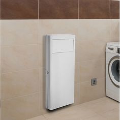 a white cabinet next to a washer and dryer in a room with tiled walls