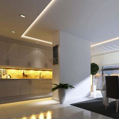 a modern kitchen and dining room with white walls, flooring and lighting on the ceiling