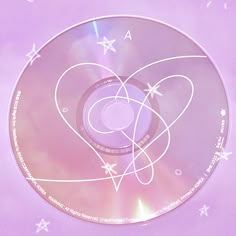 a cd that is sitting on top of a purple surface with white stars around it