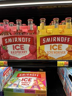 bottles of smirnoff ice raspberry and strawberry soda are on display