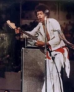 a man playing an electric guitar on stage