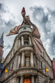 a large building with a dragon statue on top of it's roof and windows