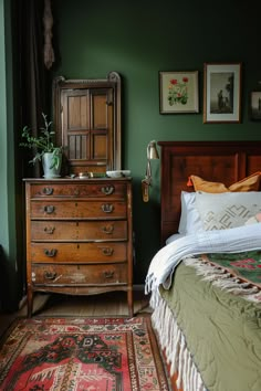 Cozy sage green bedroom featuring vintage wooden furniture, lush textiles, and sage green walls for a calming ambiance. Dark Green Master Bedrooms Decor Cozy, Sage Green And Dark Wood Bedroom, Green Bedroom Cottagecore, Dark Academia Bedroom Green, Dark Brown And Green Bedroom, Green Vintage Room, Green And Mustard Bedroom, Sage And Rust Bedroom