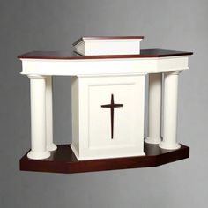 a cross on top of a table with columns and a crucifix in the middle