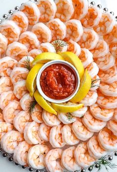 a platter filled with shrimp and dipping sauce