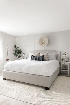 a bedroom with white walls and carpeted flooring