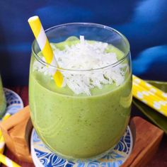 two glasses filled with green smoothie and topped with shredded white rice