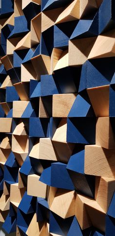 wood blocks are stacked on top of each other to create a wall mural that looks like it has been made out of plywood