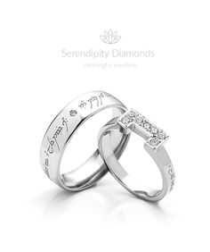 two white gold wedding rings with names engraved on the sides and diamonds in each band