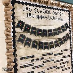 a bulletin board is decorated with black and white paper streamers that spell out the school days