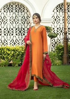 Burnt orange Rawsilk kaftan kurta with handwork on neckline & embalishments on slevees and front & back ghaira chak with tilla, zardozi & dabka. Paried with a bright Fuscia colored embossed organza duppata with emerald green borders & similar work on 4 sides. Eid Dola Silk Salwar Kameez With Naqshi, Designer Dabka Work Kurta In Chinon, Designer Dabka Kurta In Chinon, Eid Naqshi Chinon Lawn Suit, Eid Naqshi Dola Silk Dupatta, Traditional Drape Lawn Suit With Naqshi For Navratri, Dola Silk Dupatta With Naqshi For Eid, Navratri Lawn Suit With Naqshi In Traditional Drape, Navratri Dabka Kurta In Chinon