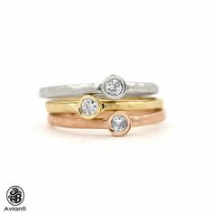 We love the modern, sophisticated look of these rings, especially when they're stacked. The rings are tricolor, with one diamond bezel set. The three rings are satin finished and hammered. Please inquire If you prefer a shiny finish. [MATERIALS] Stones: Diamonds (3) Cut: Round Carat: 0.19 Clarity: SI1 Color: I-J Setting: Bezel Measurement of the diamond: 2.50 mm Metal: 14 karat tricolor Gold, 3.90 grams. Measurement of each ring: 3.50 mm(center Width) If you prefer this ring individually here is Tricolor Rings, Tri Color Ring, Boulder Opal Necklace, Dainty Wedding Band, Journey Pendant, Boulder Opal Ring, Unique Opal, Turquoise Stud Earrings, Ring Bezel