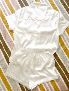 Make your bridal party experience with these luxurious Bridesmaid Pajamas, perfect for a memorable wedding photoshoot. Crafted from soft satin, these PJs offer both comfort and style, ensuring that your bridesmaids look and feel fabulous. Each set can be personalized with monograms, adding a special touch that celebrates each individual's role in the big day. The elegant design makes them ideal for bachelorette parties, where fun and relaxation go hand in hand. Imagine capturing stunning group photos of your bridal party all dressed in matching satin pajamas, creating beautiful memories that last a lifetime. These pajamas are not only a stylish choice but also a thoughtful gift that your bridesmaids will appreciate. With their chic appeal and personalized flair, they perfectly combine prac Fitted Satin Set For Wedding Night, White Short Sleeve Sets For Wedding Night, Fitted White Satin Sets, White Fitted Satin Sets, Fitted Satin Sleepwear For Wedding, White Satin Sleepwear For Wedding Night, White Satin Sets For Wedding Night, White Satin Wedding Sleepwear, Pink Satin Sets For Wedding Night