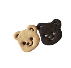 two cookies shaped like bears with faces on them