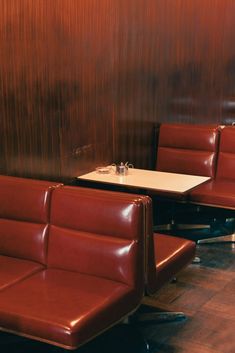 two red leather chairs sitting next to each other