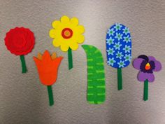 paper flowers are arranged on the side of a refrigerator