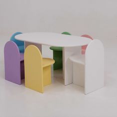 a white table and chairs with different colors on the top one is shaped like a chair