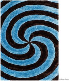 a blue and black rug with swirls on it