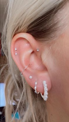 a close up of a person with ear piercings on their left and right ears