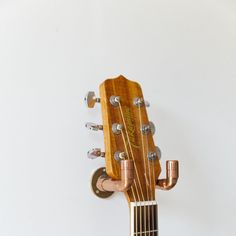 a close up of an acoustic guitar with the fret and bridge removed from its neck