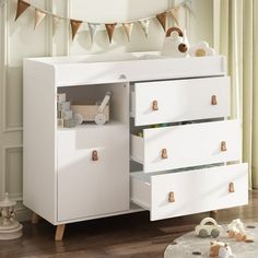 a baby's room with a dresser and toys on the floor in front of it