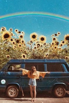 a woman standing in front of a van with sunflowers and a rainbow behind her