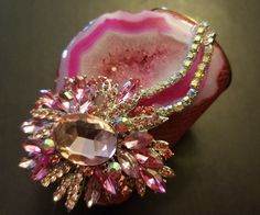 OOAK Wearable Art Cuff. A hot pink, freeform, druzy agate hosts gorgeous freeform pink agate jewel and two rows of aurora borealis rhinestones. Embellishments measure 4.5" x 3.5". The cuff is a faux pink snake print. Cuff has a gold metal interior and edge. Cuff is 4" at the widest point and tapers to narrower curve on your inner forearm. Will best fit wrists up to 7". Glamorous Party Brooch Jewelry, Pink Rhinestone Costume Jewelry, Pink Crystal Brooch Jewelry, Pink Crystal Jewelry Brooch, Pink Bling Jewelry For Evening, Dazzling Pink Jewelry With Rhinestones, Pink Evening Jewelry With Bling, Dazzling Pink Rhinestone Jewelry, Evening Pink Bling Jewelry