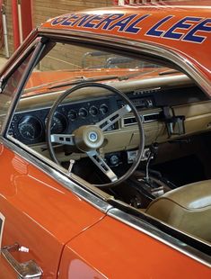 the interior of an orange classic car