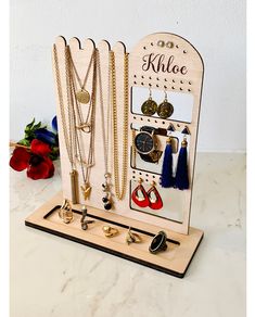 a wooden jewelry holder with necklaces and earrings