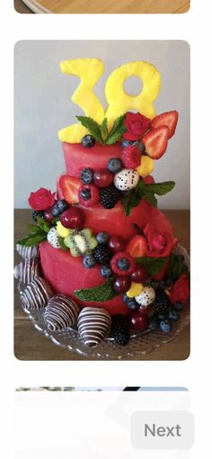 the cake is decorated with fruits and berries