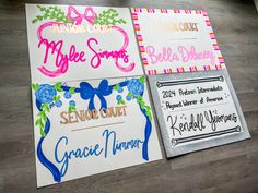 three different colored paper signs on top of a wooden floor next to a sign that says congratulations