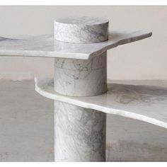 two white marble benches sitting next to each other