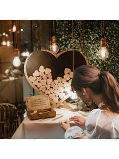 a woman sitting at a table in front of a heart shaped box with hearts on it