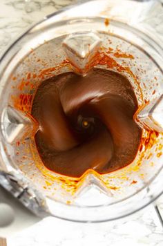 a food processor filled with chocolate and orange liquid