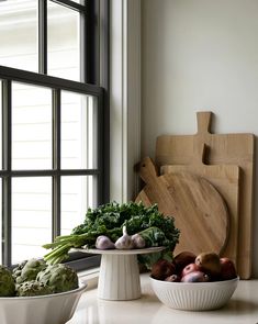 there are many vegetables on the counter in this kitchen