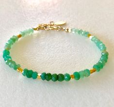 Lovely natural green chrysoprase gemstone beaded bracelet with 24k gold vermeil accents.  Beautiful Australian chrysoprase gems are 4mm faceted rondelles in luscious shades of light to darker apple green. 2mm faceted 24k solid gold vermeil cubes add sparkling accents. Made to order on professional beading wire with 14k gold fill spring ring clasp and findings. A little 22k gold vermeil leaf charm dangles from 1" extension. Also available in .925 Sterling silver. Green Onyx Beaded Bracelets As Gift, Green Gemstone Rondelle Beaded Bracelets, Green Spiritual Bracelets With Faceted Beads, Spiritual Green Bracelets With Faceted Beads, Green Rondelle Bracelets With Faceted Beads, Green Rondelle Beaded Spiritual Bracelets, Green Onyx Round Beads Bracelets, Green Rondelle Beaded Bracelets With Faceted Beads, Green Faceted Round Bead Bracelets