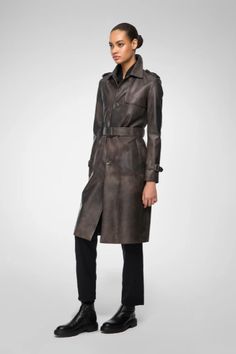 Women's Belted Leather Coat In Coffee Brown Step into sophistication with our women's belted leather coat in coffee brown. Made from genuine sheepskin leather with a semi-aniline finish, this coat combines luxury and durability. It features a stylish belted waist, turn-down collar, and button closure for a timeless look. Open hem cuffs with straps add a unique touch. Practicality is ensured with one inside pocket and two side pockets. This coffee-brown leather coat is the perfect blend of elegan Leather Shorts Women, Short Leather Skirts, Brown Leather Coat, Leather Coat Womens, Leather Jumpsuit, Shearling Vest, Sheepskin Jacket, Studded Jacket, Distressed Jacket