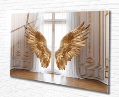 an image of two golden wings in front of a window