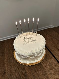 a birthday cake with candles on it that says happy birthday written on the frosting