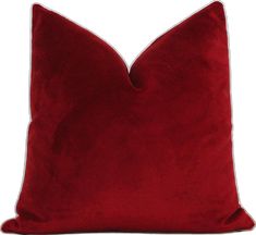 a red velvet pillow with white piping on the bottom and side, sitting on a white background