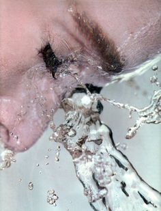 a woman's eye is partially submerged in water