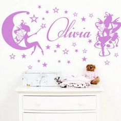 a white dresser topped with a teddy bear next to a wall mural that says aurora