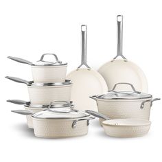 an assortment of white pots and pans with silver handles on a white background,