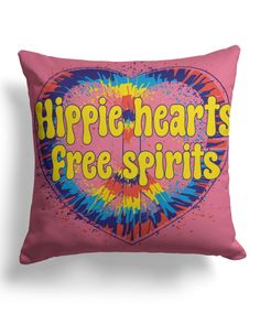 a pink pillow with the words hippie hearts free spirits in yellow and blue on it